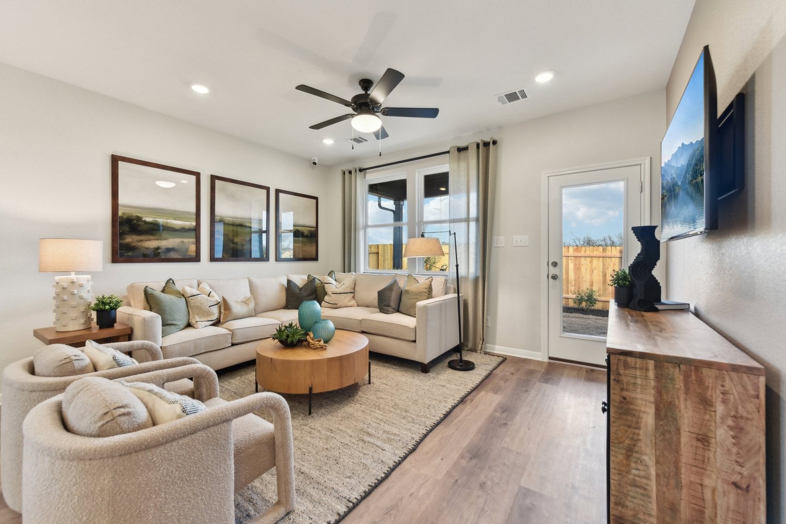 253 Firefox Way Jarrell, TX 76537 - Photo 4 of 17 A well-lit living area with hardwood-style flooring offers a comfortable and inviting atmosphere.