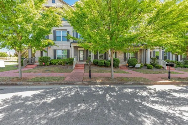a front view of a house with yard and green space