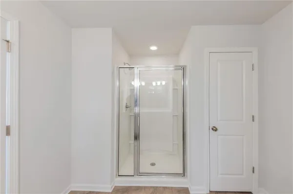 a bathroom with a glass shower door