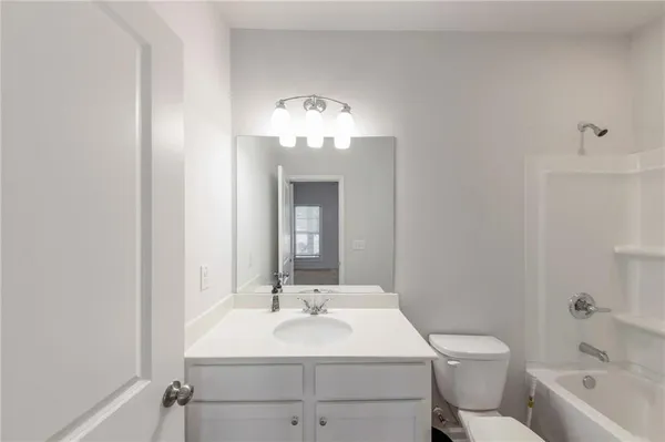 a bathroom with a toilet a sink and a mirror