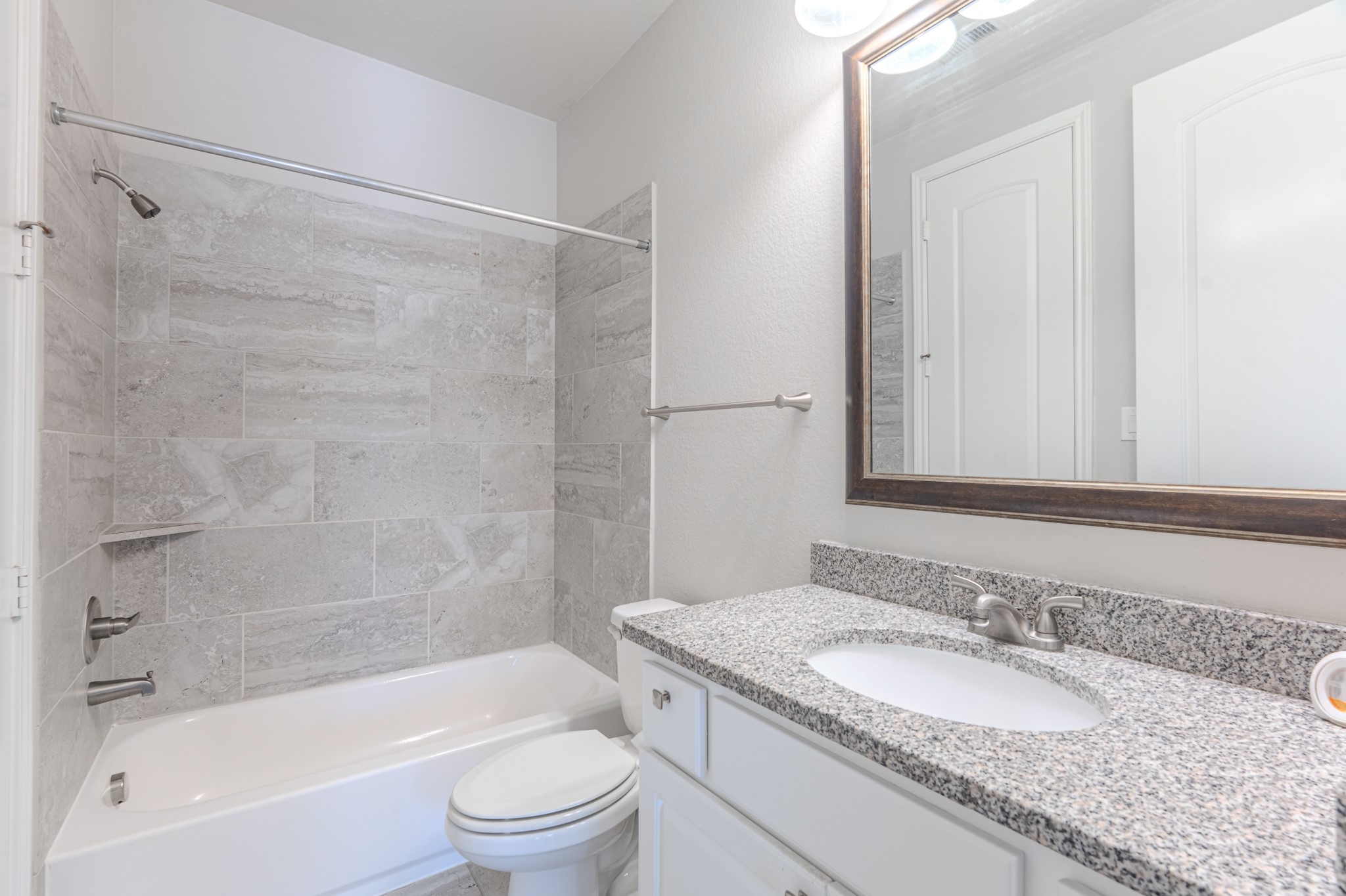 27918 Madison Bend Drive Spring, TX 77386 - Photo 32 of 50 a bathroom with a granite countertop bathtub shower sink vanity mirror and toilet