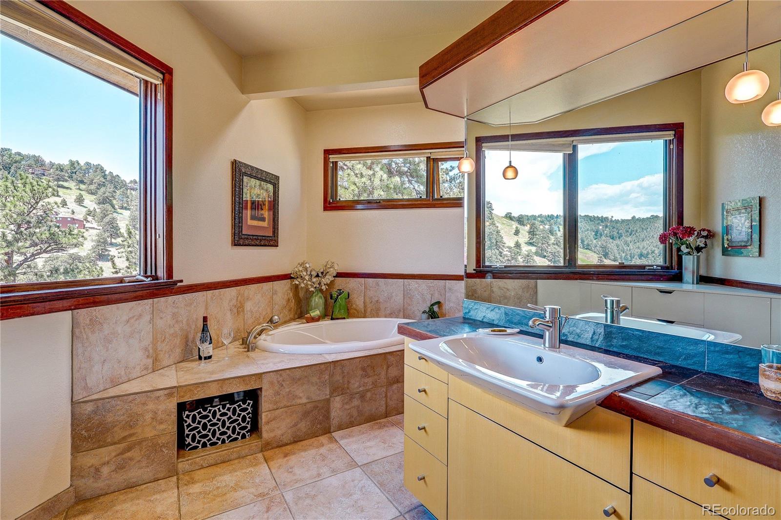 147 Alpine Avenue Golden, CO 80401 - Photo 22 of 47 a bathroom with a tub a sink and large window