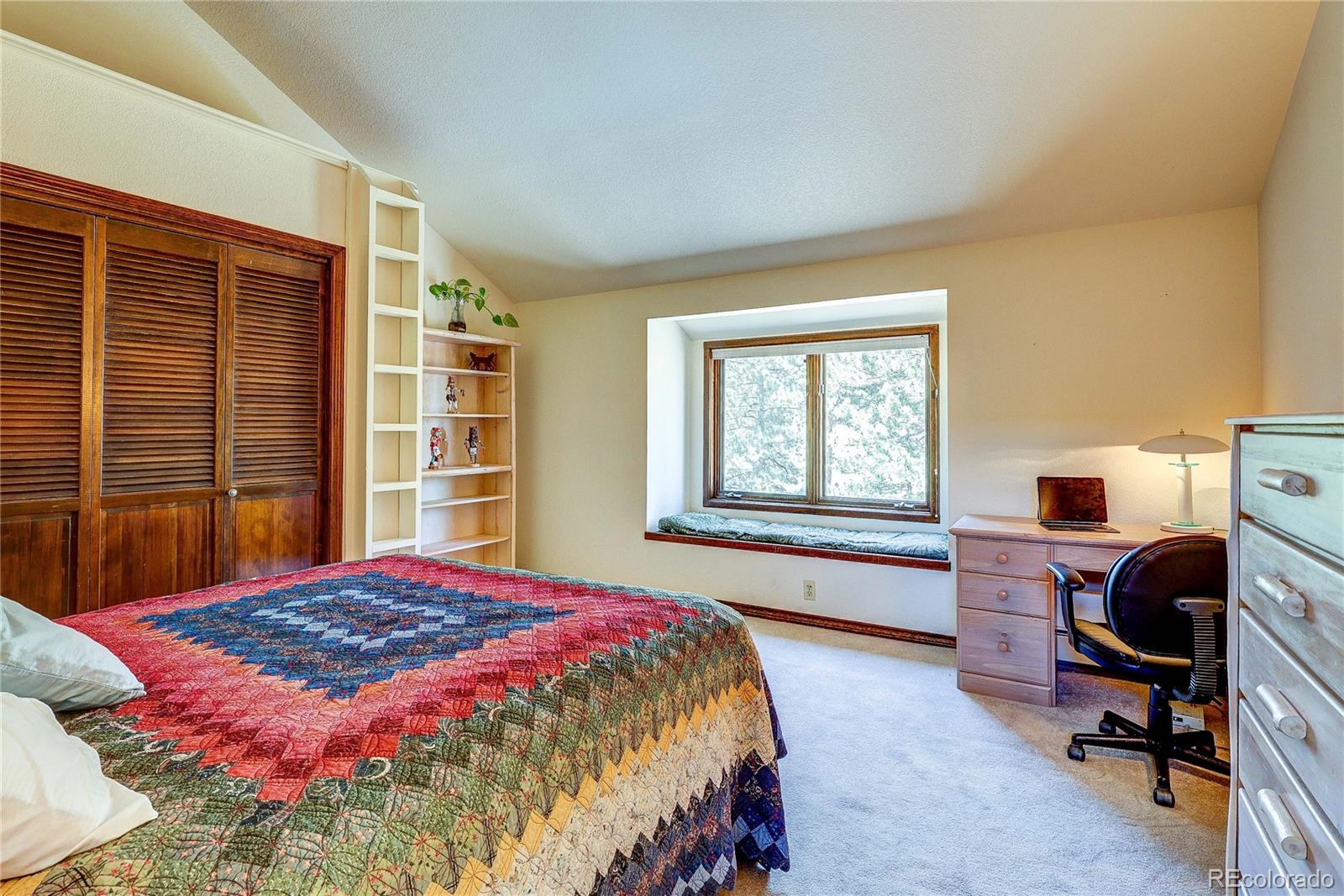 147 Alpine Avenue Golden, CO 80401 - Photo 26 of 47 a bed sitting in a bedroom next to a window