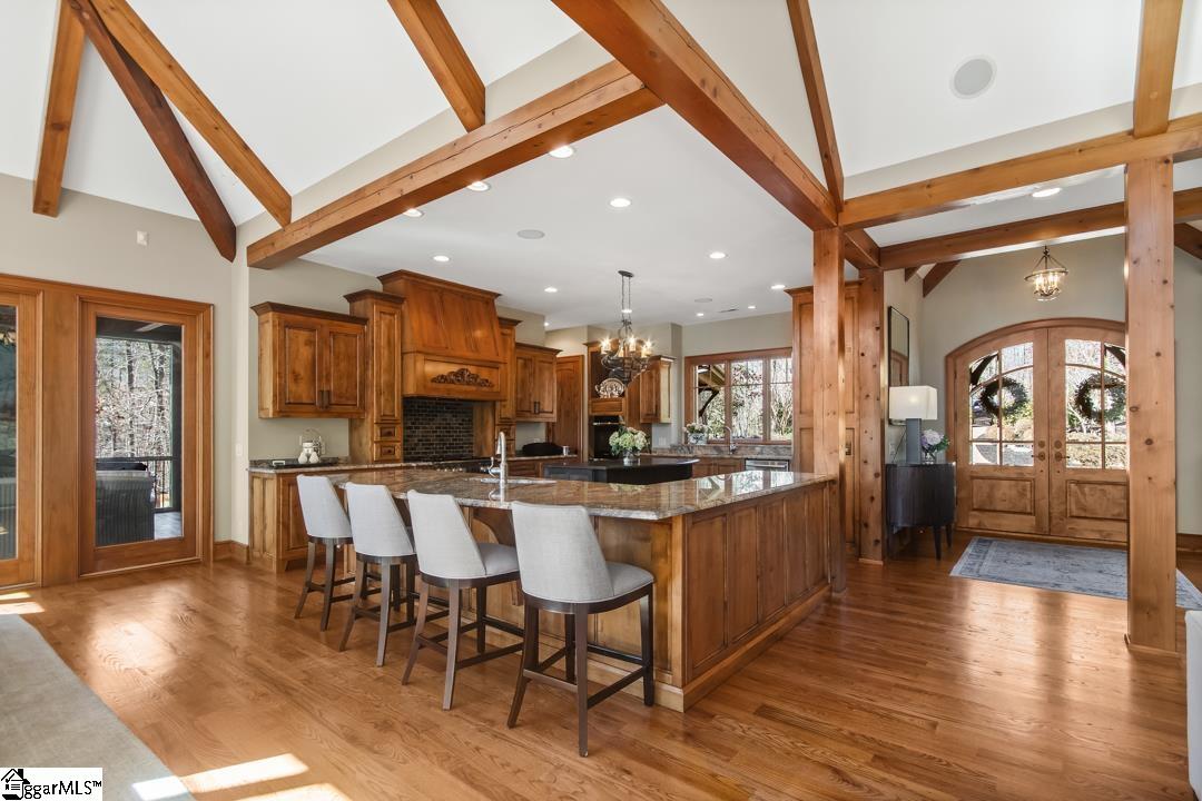 206 Feather Bell Lane Sunset, SC 29685 - Photo 10 of 50 A spacious kitchen island is complemented by a row of upholstered bar stools, creating a comfortable, social perch for casual meals and conversation.