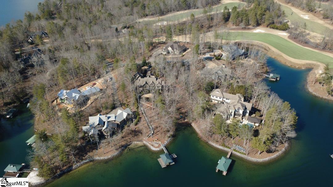 206 Feather Bell Lane Sunset, SC 29685 - Photo 3 of 50 An aerial perspective showcases a quiet waterfront enclave with estate homes tucked among mature trees, private docks, and a seamless connection to lake and golf course living.