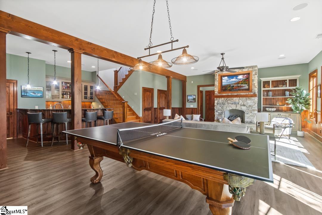 206 Feather Bell Lane Sunset, SC 29685 - Photo 30 of 50 This expansive recreation room offers versatile either pool or ping pong, featuring a wet bar and a grand stone fireplace.