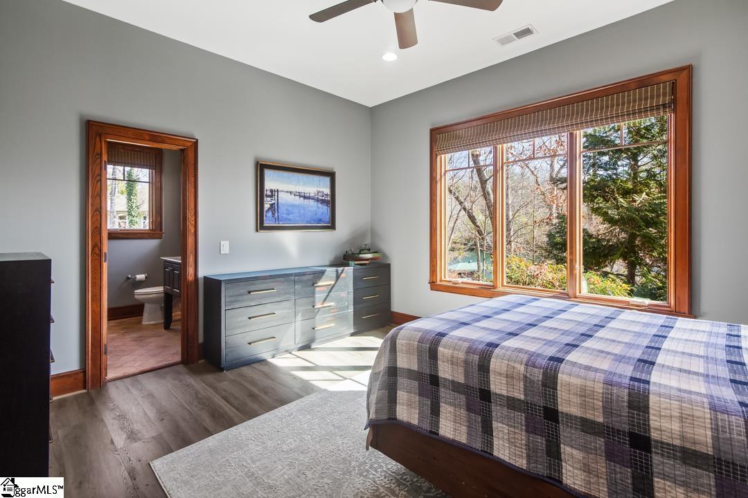 206 Feather Bell Lane Sunset, SC 29685 - Photo 34 of 50 This serene bedroom offers ample light and scenic views, with an adjoining bathroom for convenience.