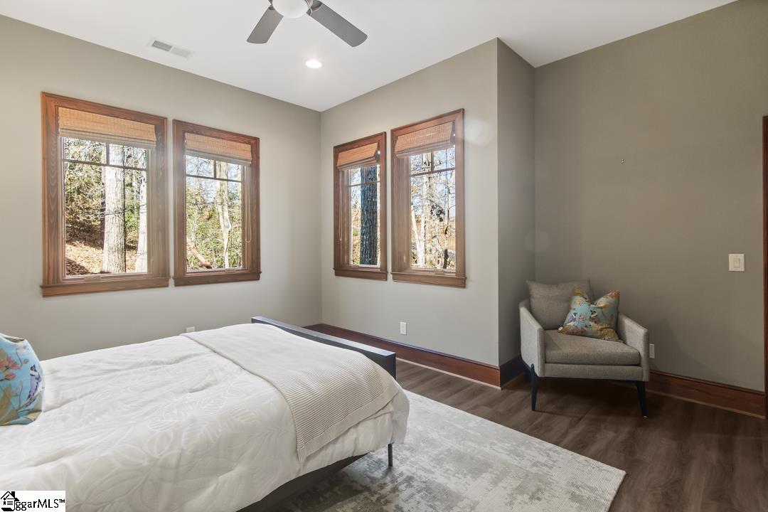 206 Feather Bell Lane Sunset, SC 29685 - Photo 36 of 50 This tranquil bedroom offers abundant natural light and serene wooded views, creating a peaceful retreat.
