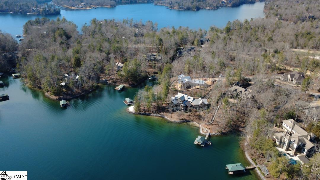 206 Feather Bell Lane Sunset, SC 29685 - Photo 4 of 50 This aerial view showcases a serene lakefront property with private docks and lush surroundings.