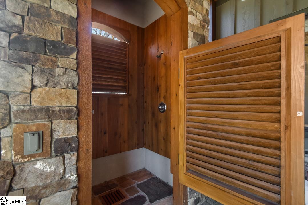 206 Feather Bell Lane Sunset, SC 29685 - Photo 40 of 50 This outdoor shower features a natural stone wall and wood accents for a rustic feel.