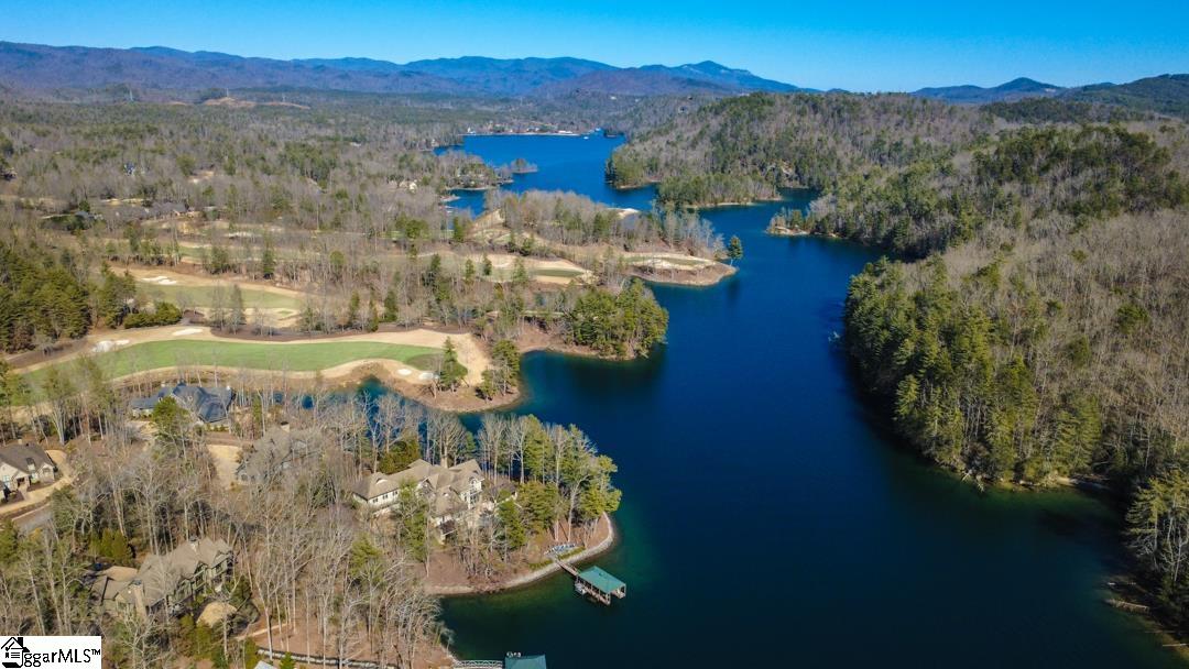 206 Feather Bell Lane Sunset, SC 29685 - Photo 48 of 50 A breathtaking aerial reveals deep blue Lake Keowee winding through rolling mountain terrain, private coves, and manicured golf fairways in a setting that feels both secluded and expansive.