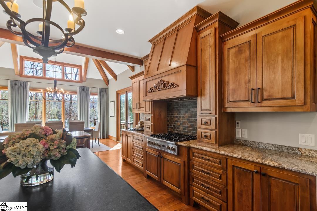 206 Feather Bell Lane Sunset, SC 29685 - Photo 7 of 50 Warm wood cabinetry and granite counters define this inviting kitchen.