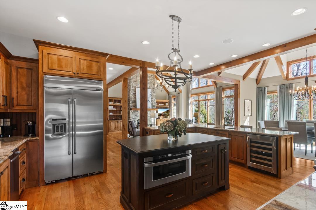 206 Feather Bell Lane Sunset, SC 29685 - Photo 8 of 50 The expansive kitchen features gleaming hardwood floors and natural light, creating an ideal space for gatherings.