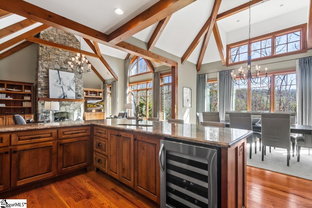 206 Feather Bell Lane Sunset, SC 29685 - Photo 50 of 50 The open floor plan seamlessly blends a functional kitchen with a bright dining area, featuring high vaulted ceilings.