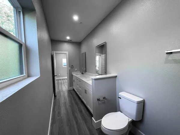 a bathroom with a toilet sink and mirror