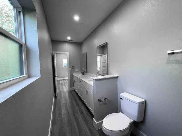 a bathroom with a toilet sink and mirror