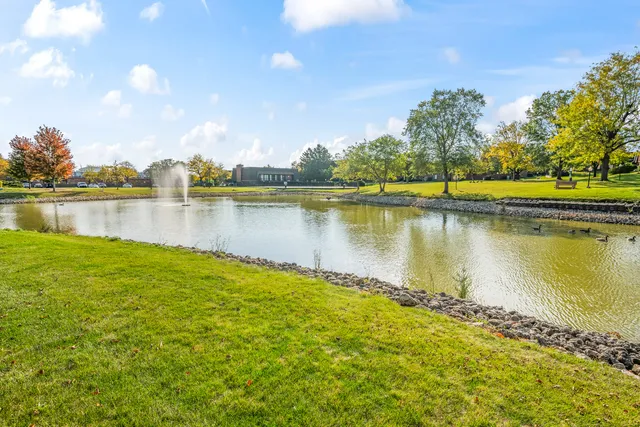 a view of a lake with houses in the back