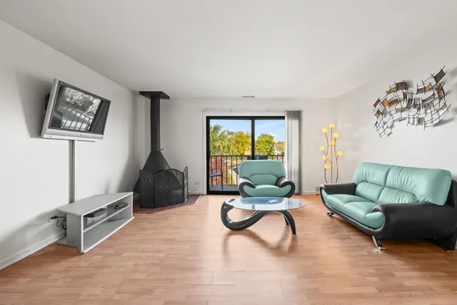 a living room with furniture a rug and a large window