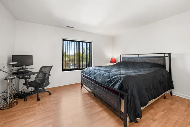 a bed room with a bed and a chair