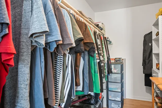a view of walk in closet with clothes
