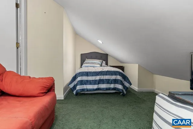 a bedroom with bed and a couch