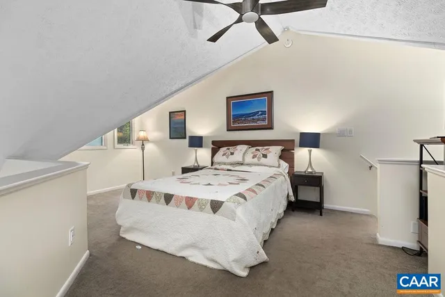 a bedroom with a bed and a refrigerator