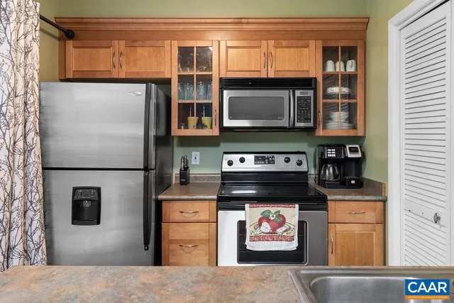 a kitchen with stainless steel appliances granite countertop a stove and a refrigerator