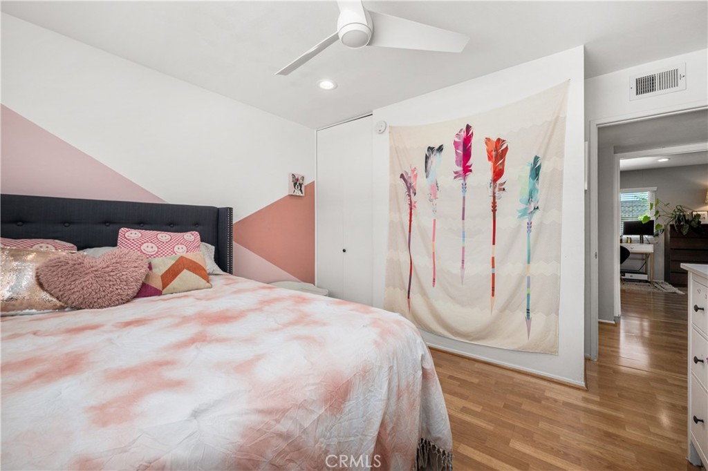 4237 Larwin Avenue Cypress, CA 90630 - Photo 29 of 48 a bedroom with a large bed and a chandelier