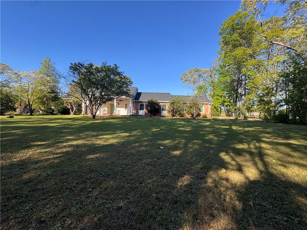 2211 East River Street Anderson, SC 29621 - Photo 1 of 40 This spacious property offers a welcoming facade with a broad expanse of green lawn and mature trees.