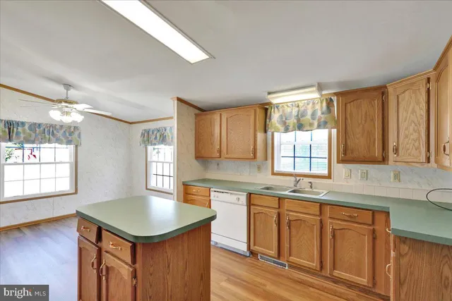 a kitchen with a sink cabinets and window