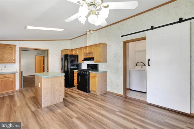 a kitchen with stainless steel appliances granite countertop a refrigerator and a stove top oven