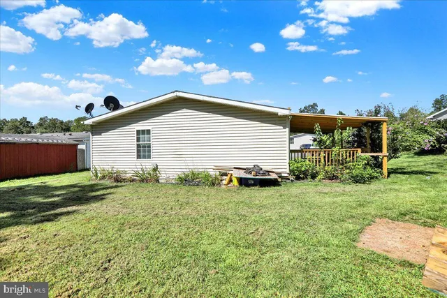 a house view with swimming pool and garden