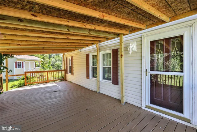 a view of porch with wooden floor