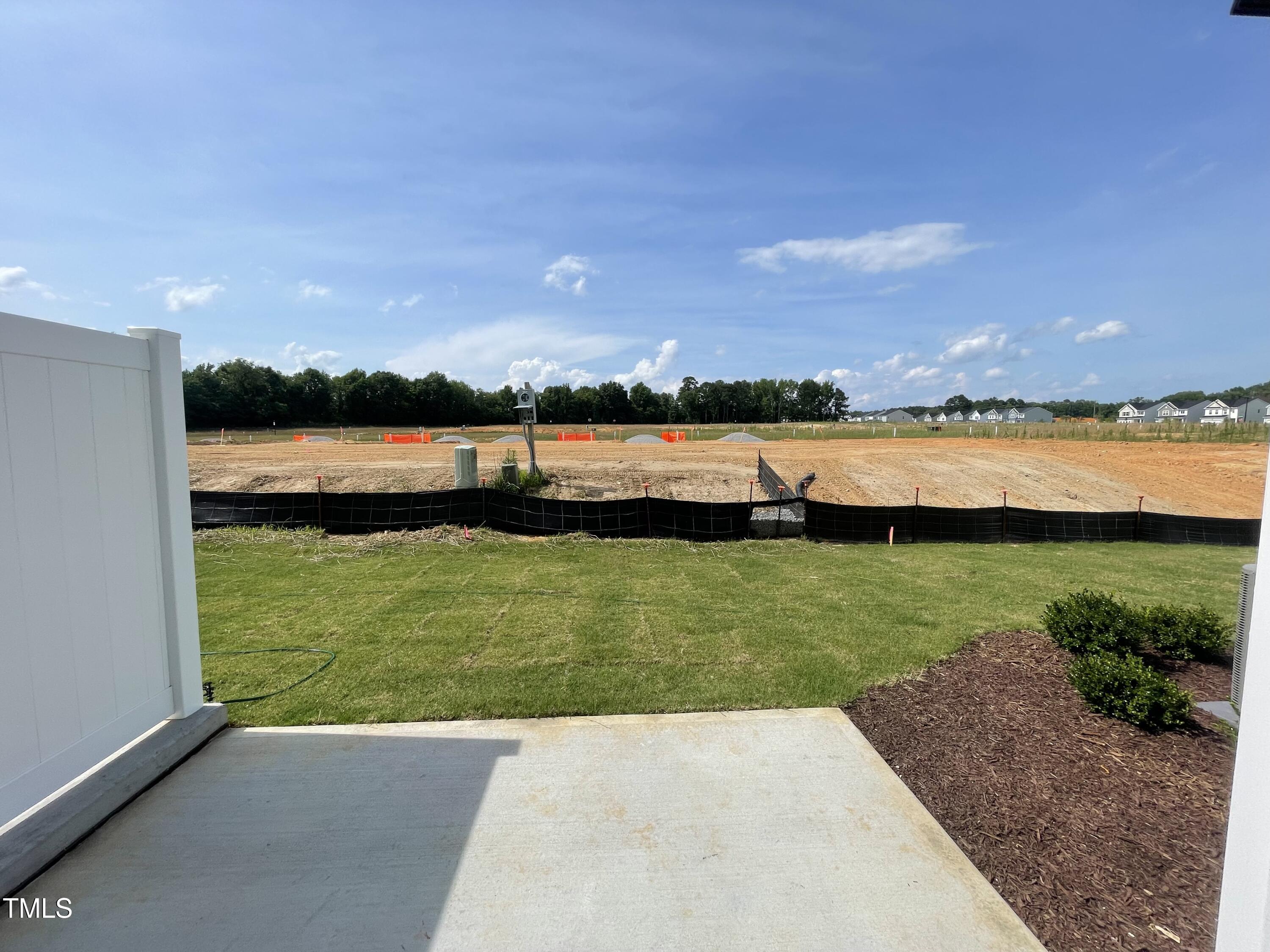 351 Thompson Overlook Way Smithfield, NC 27577 - Photo 10 of 11 a view of a lake with houses in the back