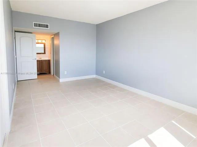 an empty room with closet and a window