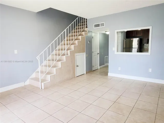 a view of entryway with stairs and wooden floor