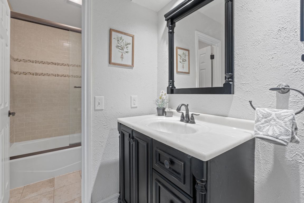 4706 Cap Rock Drive Austin, TX 78735 - Photo 16 of 40 a bathroom with a sink and a mirror
