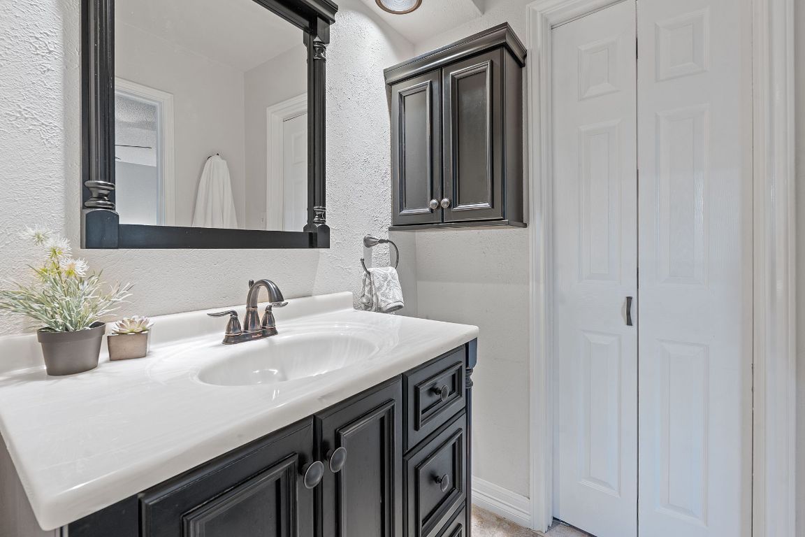 4706 Cap Rock Drive Austin, TX 78735 - Photo 17 of 40 a bathroom with a sink and a mirror