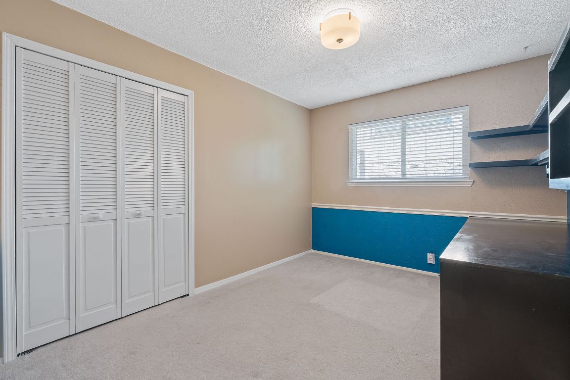 4706 Cap Rock Drive Austin, TX 78735 - Photo 19 of 40 a bedroom with a bed and a window