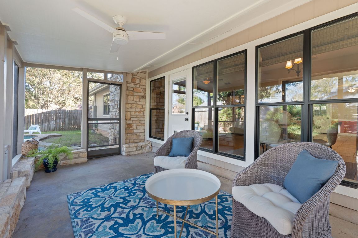 4706 Cap Rock Drive Austin, TX 78735 - Photo 22 of 40 a living room with furniture and a floor to ceiling window