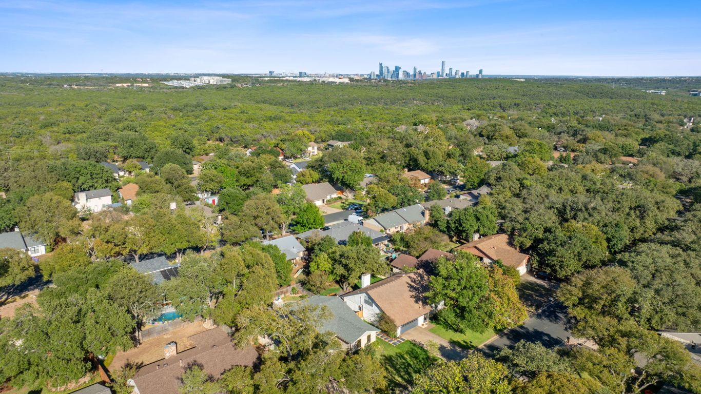 4706 Cap Rock Drive Austin, TX 78735 - Photo 35 of 40 a view of a green field with lots of trees in the background