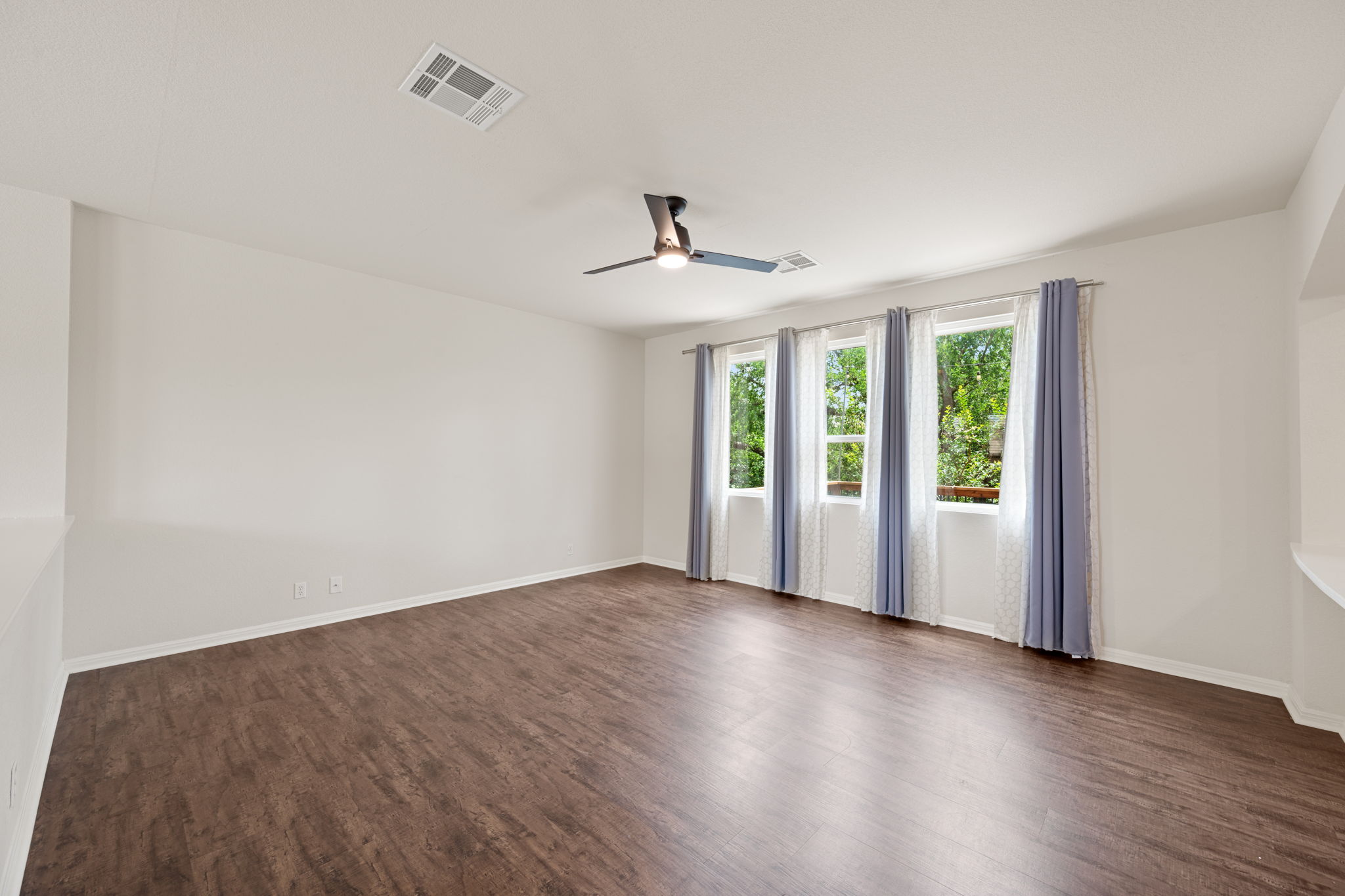 8902 Magna Carta Loop, Unit 122 Austin, TX 78754 - Photo 7 of 39 Rich hardwood floors complement the natural light flowing through multiple windows in this inviting space.