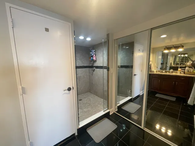 a bathroom with a shower and a mirror