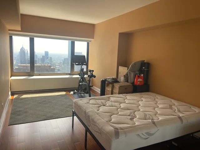 a living room with furniture and a floor to ceiling window