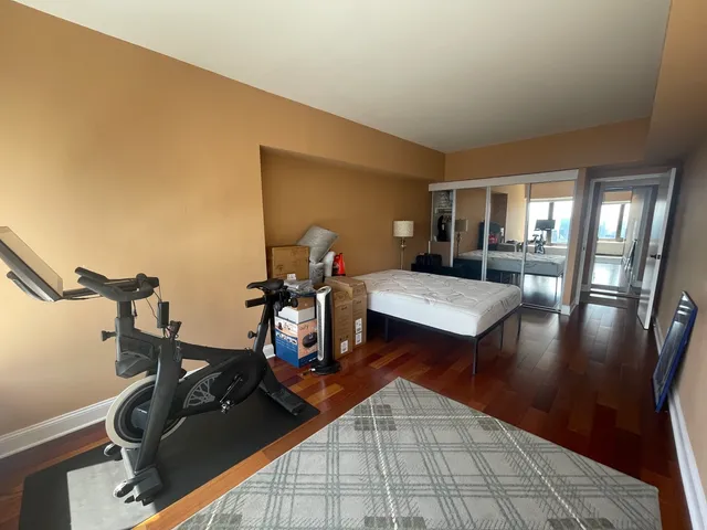 a living room with dining room and wooden floor