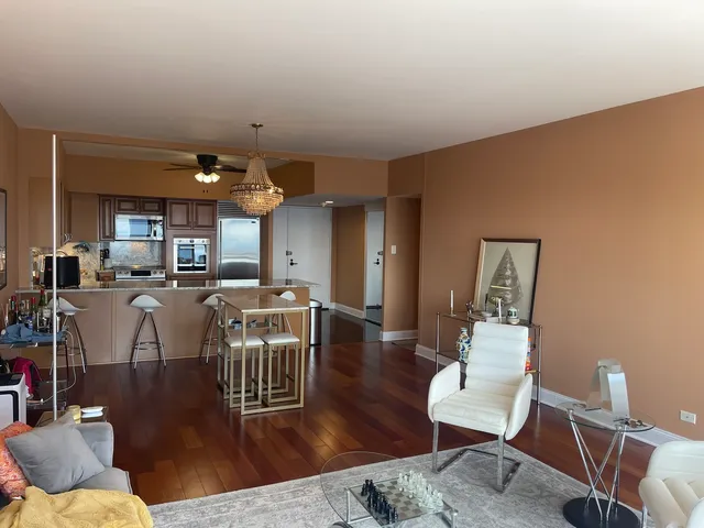 a living room with lots of furniture and a wooden floor