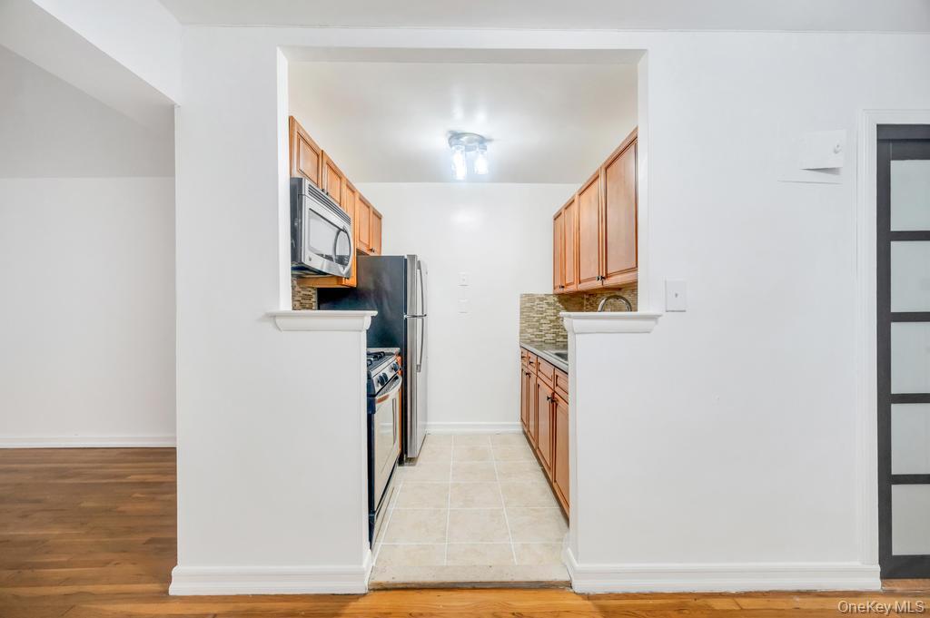 3123 Bailey Avenue, Unit 4A Bronx, NY 10463 - Photo 12 of 27 a view of a kitchen with refrigerator and a window
