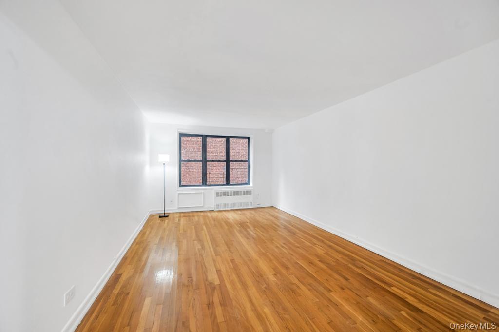 3123 Bailey Avenue, Unit 4A Bronx, NY 10463 - Photo 17 of 27 a view of an empty room with window and wooden floor