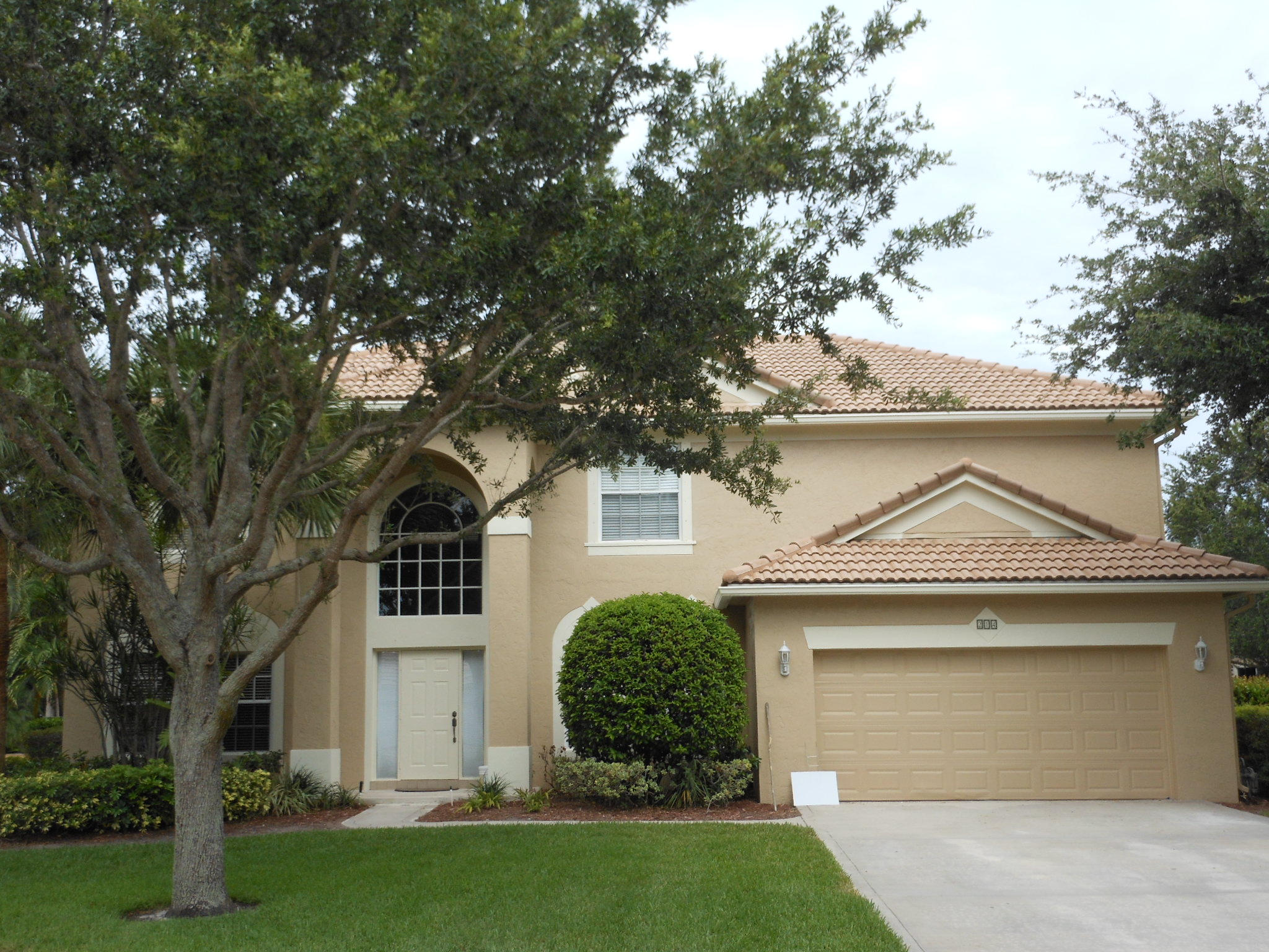 214 Anhinga Lane Jupiter, FL 33458 - Photo 1 of 1 a front view of a house with a yard and a garage
