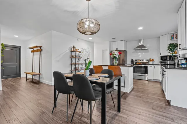 a view of a dining room with furniture and wooden floor